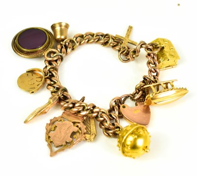 Lot 259 - A 9ct gold charm bracelet with various charms...