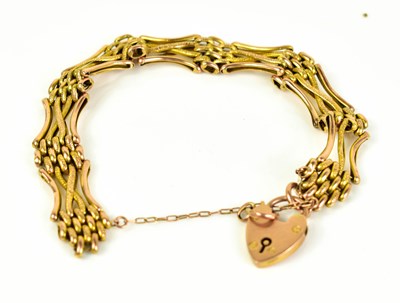 Lot 209 - A 9ct gold gate link bracelet with padlock...