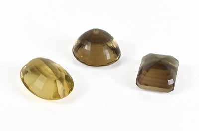 Lot 94 - Three loose cut gemstones, to include smoky...