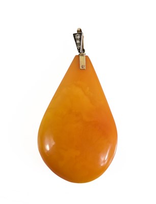 Lot 88 - An amber, gold and diamond pendant; the gold...
