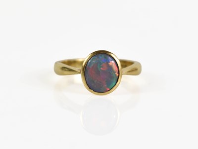 Lot 200 - An 18ct gold and opal ring, the circular black...