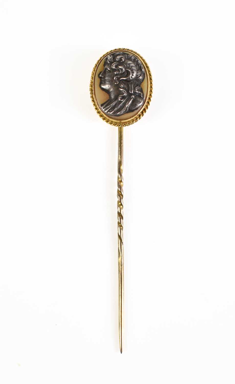 Lot 39 - A gold hat / stick pin set with a pale cream...