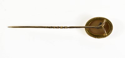Lot 39 - A gold hat / stick pin set with a pale cream...