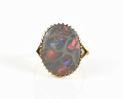 Lot 223 - An unusual 18ct gold and opal ring, the oval...