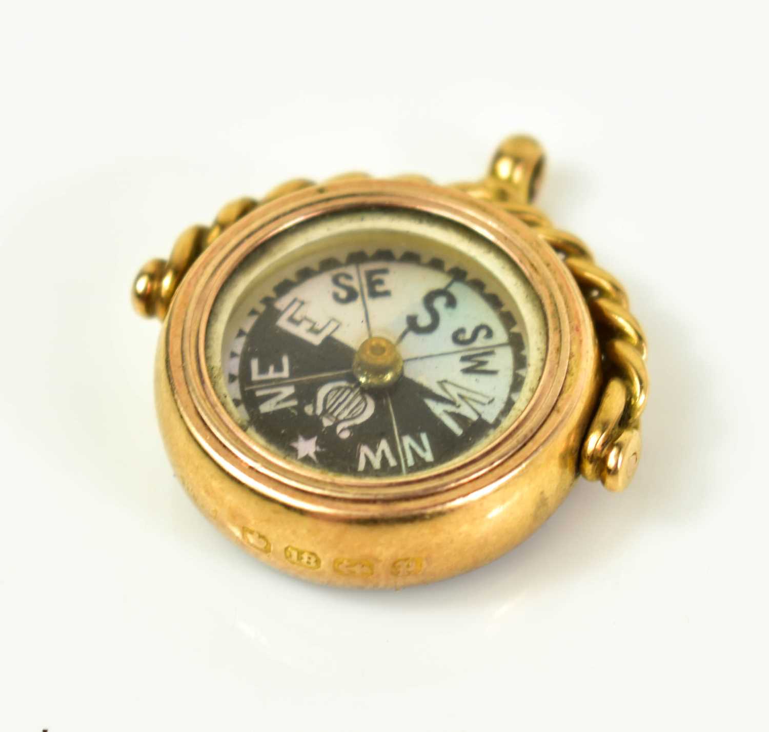 Lot 7 - An 18ct gold fob with mother of pearl compass...
