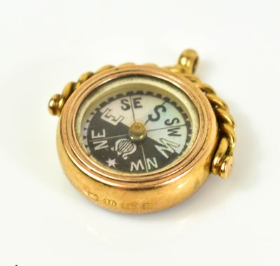 Lot 7 - An 18ct gold fob with mother of pearl compass...