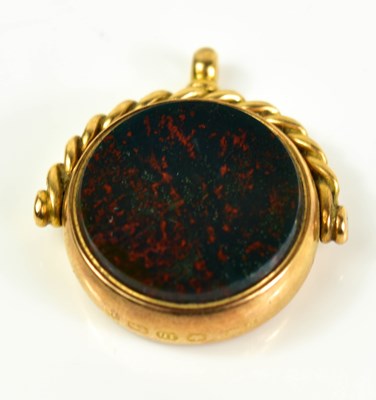 Lot 7 - An 18ct gold fob with mother of pearl compass...