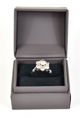 Lot 17 - An 18ct white gold and diamond flowerhead ring,...