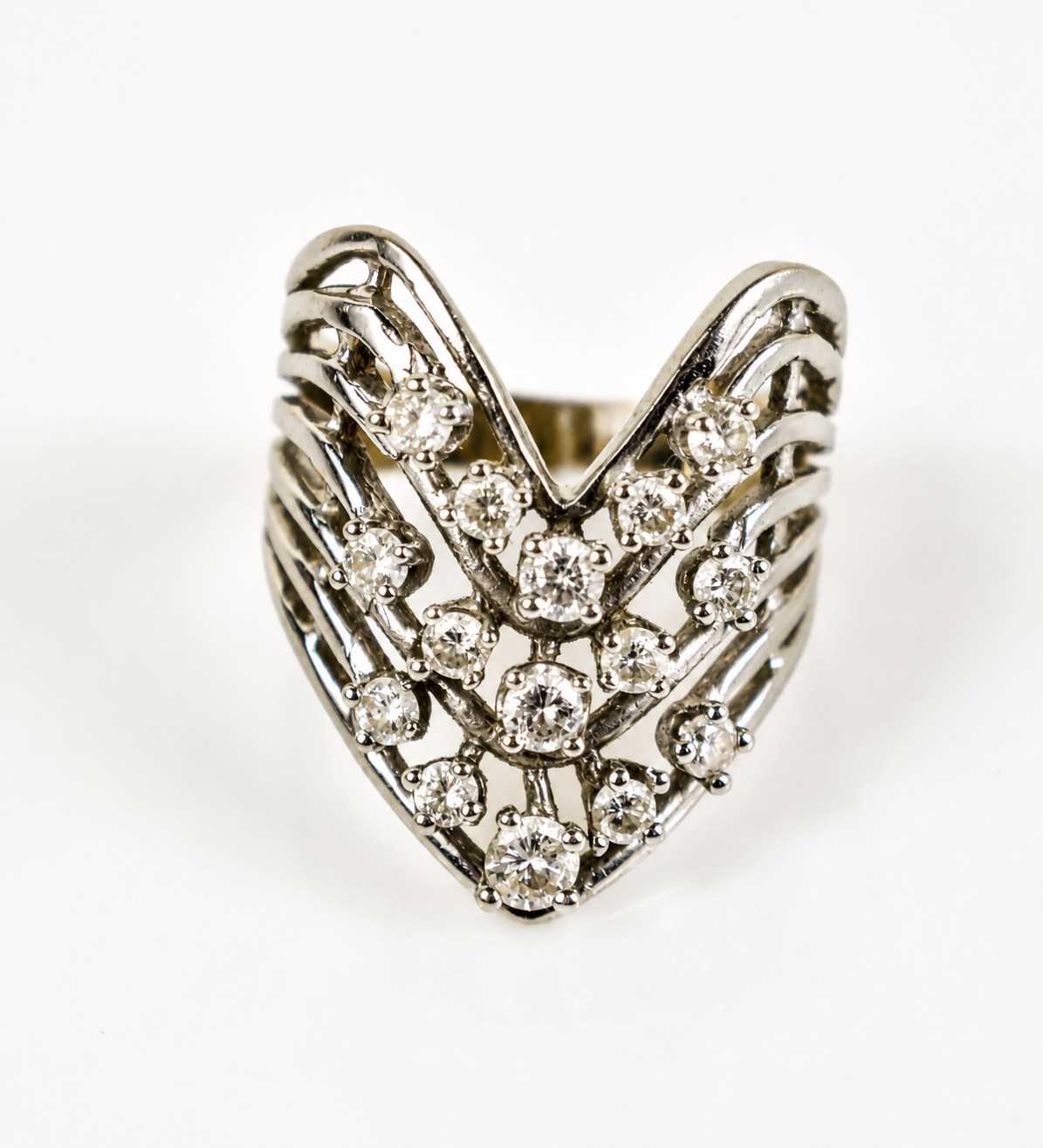 Lot 13 - A 14ct white gold and diamond V-form cluster...