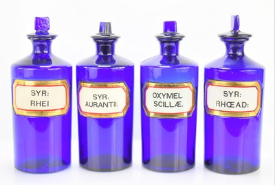 Lot 1 - Four antique blue glass apothecary bottles...