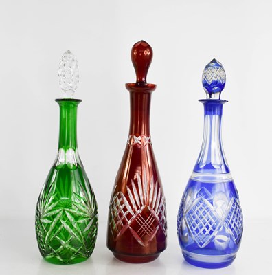 Lot 103 - Three Bohemian cut glass decanters in green...