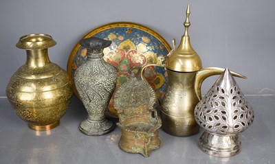 Lot 67 - A white metal Angkor candle stand, together...