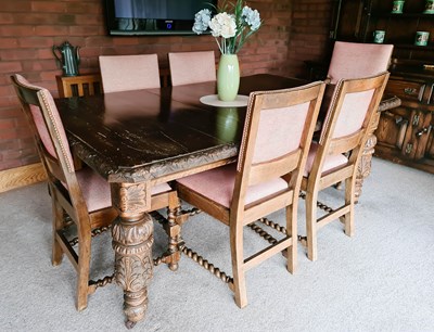 Lot 213 - An oak dining table, with cup and cover carved...