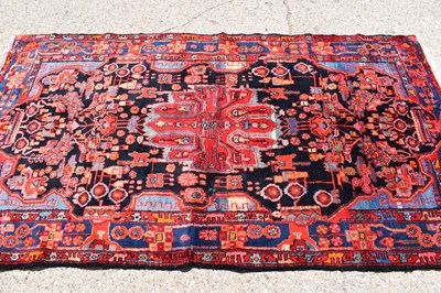 Lot 434 - A Middle Eastern red ground wool rug, hand...
