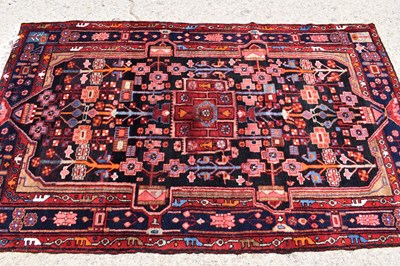 Lot 435 - A Middle Eastern red ground wool rug, the...