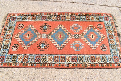 Lot 429 - A Persian wool rug with orange ground, triple...