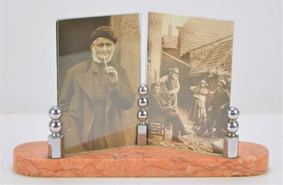 Lot 27 - An Art Deco photo frame on a marble base with...