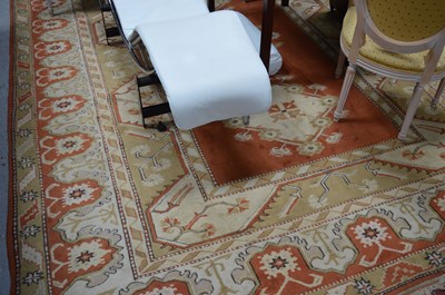 Lot 215 - A large wool rug, orange ground, diamond...