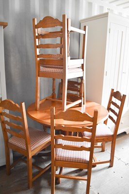 Lot 236 - A small dining table and six ladder back...