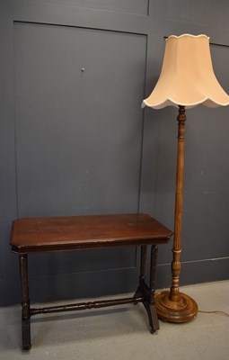 Lot 228 - An oak standard lamp with cream shade together...