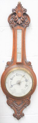 Lot 14 - A Victorian carved oak cased aneroid barometer,...
