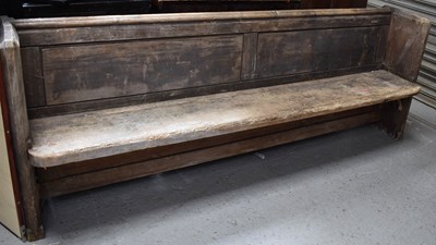 Lot 485 - A long pine church pew, 82cm high by 222cm by...