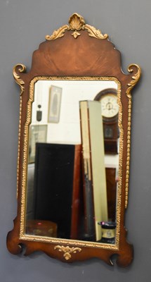 Lot 411 - A reproduction mahogany and gold painted wall...