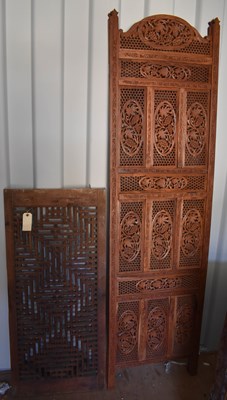 Lot 489 - A bi-fold Indonesian hardwood carved screen,...
