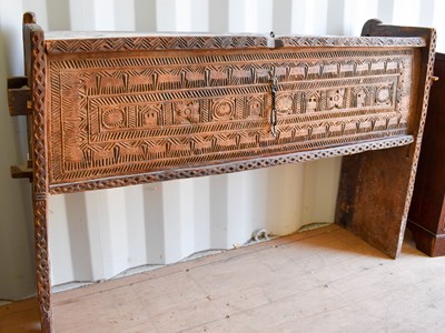 Lot 507 - A boarded wooden chest, raised on tall end...