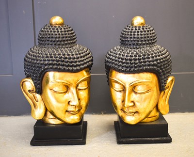 Lot 477 - A pair of 20th century Buddha heads, with...