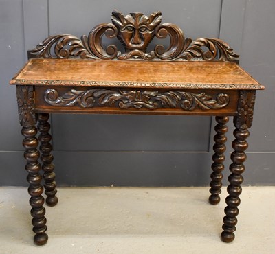 Lot 483 - An oak 1930s silver table, the carved back...
