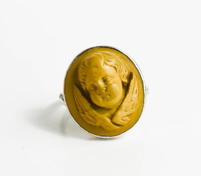 Lot 37 - A white metal ring, with relief moulded stone...