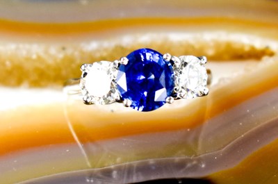 Lot 161 - A platinum, blue sapphire and diamond three...