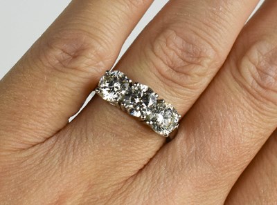 Lot 181 - A platinum and diamond trilogy ring, each...