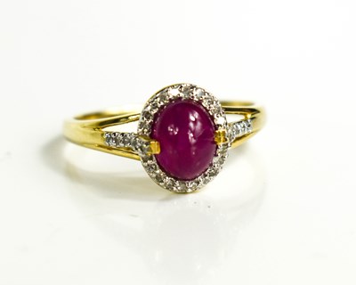 Lot 140 - A 9ct gold cabochon ruby and diamond ring,...
