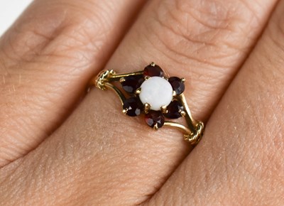 Lot 89 - A 9ct gold, opal and garnet set flower head...
