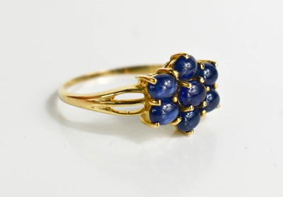 Lot 106 - A 9ct gold cabochon sapphire flower head...