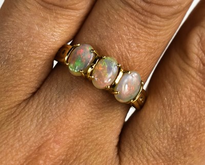 Lot 132 - A 9ct gold oval opal trilogy ring, size R, 3g.