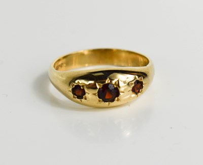 Lot 131 - A 9ct gold, garnet three stone antique style...