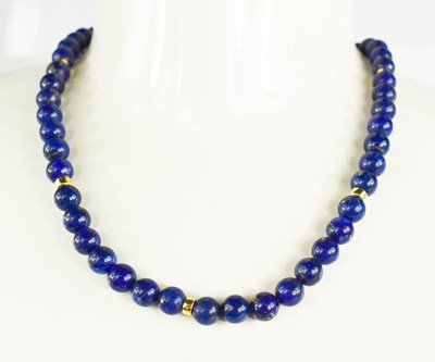Lot 26 - An 18ct gold and lapiz lazuli beaded necklace,...