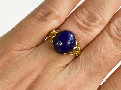 Lot 23 - An 18ct gold and lapiz lazuli cabochon oval...