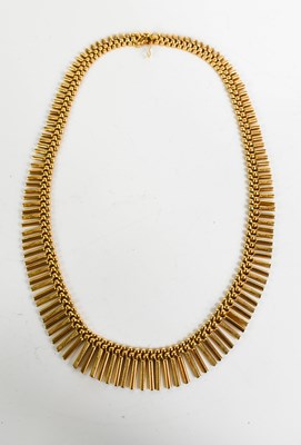 Lot 176 - An 18ct gold Egyptian style articulated fringe...