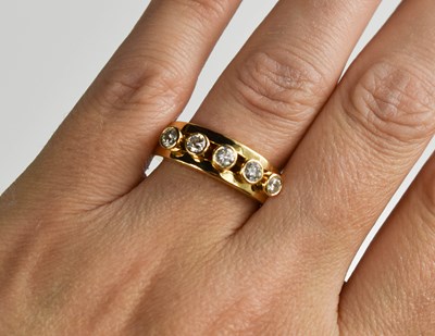 Lot 175 - A 18ct gold and diamond five stone ring, the...
