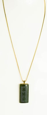 Lot 10 - A jade and 9ct gold pendant necklace, the jade...