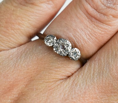 Lot 35 - A platinum and 9ct gold ring, with three chip...