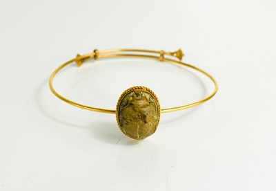 Lot 39 - A 14ct gold Egyptian bangle, with a stone...