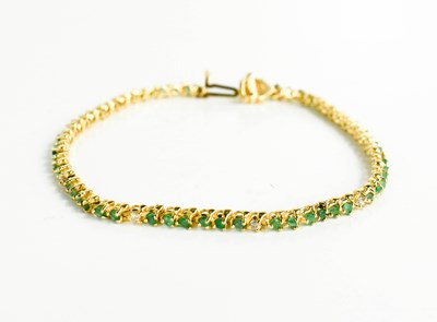 Lot 42 - A 14ct yellow gold, diamond and emerald set...