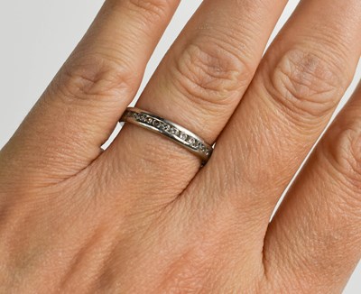 Lot 43 - A platinum and diamond full hoop eternity ring,...