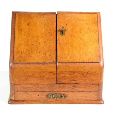 Lot 27 - An early 20th century two door oak stationery...