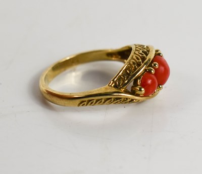 Lot 10 - A 9ct gold and coral three stone ring.